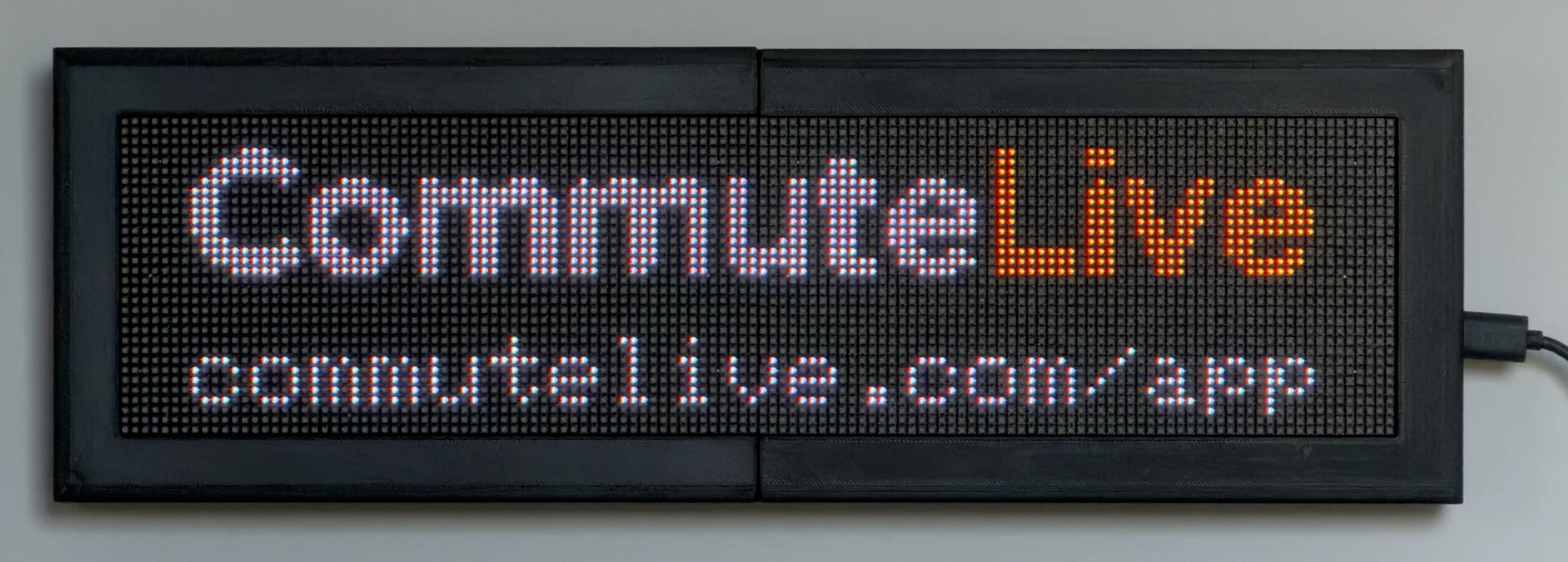 CommuteLive display plugged in, showing the CommuteLive name and commutelive.com/app